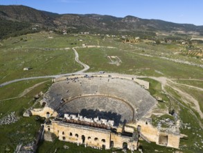 A panorama of an ancient theatre in a vast green landscape, amphitheatre, aerial view, Hierapolis,