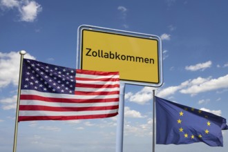 (Photomontage) Symbolic image of the customs agreement between the EU and the USA: town sign with