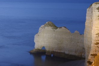 Cliffs with the Porte d'Amont rock gate at dusk, Etretat, Alabaster Coast, Seine-Maritime,