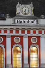 Hamm main station, façade with station clock and sculptures of a wire-drawer and a miner at the
