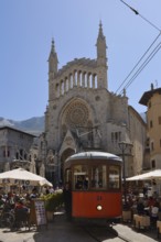 Historic tram Red Lightning in front of the church of Sant Bartomeu, Soller, Majorca, Balearic