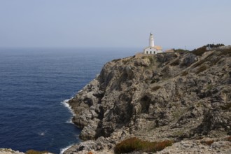 Rocky coast and Far de Capdepera lighthouse, Punta de Capdepera, Cala Rajada, Majorca, Balearic