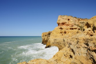 Surf on the rocky coast, Carvoeiro, Algarve, Portugal