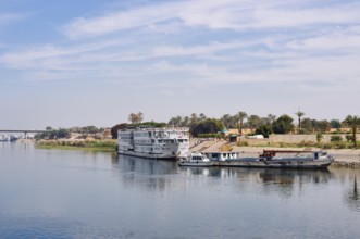 Nile cruise ship and boats at a jetty near Luxor, Egypt