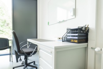 A modern office with desk and chair by the window, Care Connect, vaccination kiosk for refugees,
