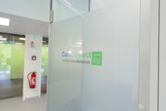 Glass wall with CareConnect logo in a modern office environment, Care Connect, vaccination kiosk