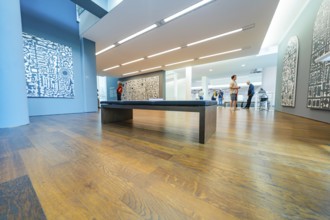 Room with modern architecture and exhibited artworks, animated by visitors, Frieder Burda Museum,