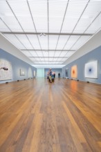 Large, illuminated gallery space with several visitors and works of art on the walls, Frieder Burda