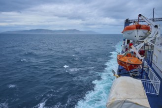 View from a ferry on stormy sea and lifeboats with coastal distance, summer, Cook Strait, North