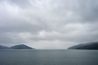 Tranquil landscape with sea and cloudy sky between islands, summer, Cook Strait, North Island,