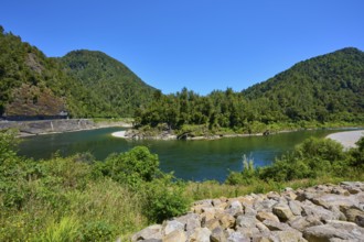 Clear river landscape surrounded by forested mountains and bright blue sky, Kilkenny Lookout, Lower