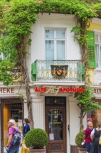 Historic pharmacy building with overgrown façade in the city, Baden Baden, Germany