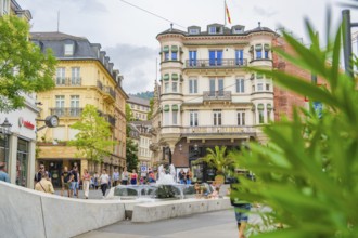 Town square with a fountain and historic buildings, bustling with people, Baden Baden, Germany