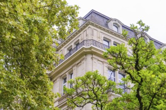 An elegant historic building with ornate details and lush trees that frame, Baden Baden, Germany