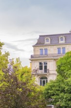 Classic building with richly decorated façade and windows, surrounded by trees, Baden Baden,
