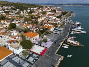 Coastal town with promenade, boats and palm trees, offers a relaxing view, aerial view, Alibey,