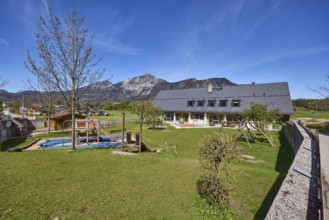 Catholic kindergarten St.Bruder Klaus, building, playground equipment, swing, sandpit, meadow,