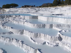 Natural limestone sinter terraces in Pamukkale under a clear sky, aerial view, sinter terraces,