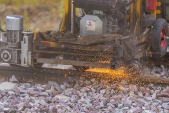 Close-up of spraying welding sparks while working on a railway track, grinding work on the Hermann