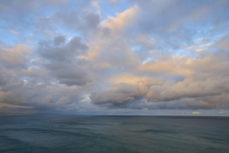View of the sea under a sky with soft pastel colours at sunset, summer, Nugget Point Lighthouse,