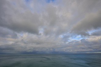 Expansive cloudy sky over a calm sea, summer, Nugget Point lighthouse, Ahuriri Flat, Otago, South