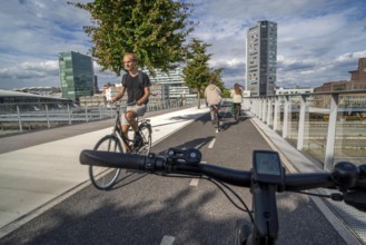 Cycling over the Moreelsebrug, pedestrian and cyclist bridge over the tracks of Utrecht Centraal,