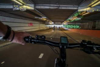 Ride your bike through the tunnel under the tracks of Utrecht Central, HBF, on the central cycle