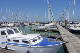 Recreational motorboats and sailing boats moored in marina of fishing village and seaside resort