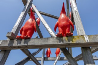 Rode Pinguins, Red Penguins, artwork by Belgian artist William Sweetlove in the harbour of Breskens
