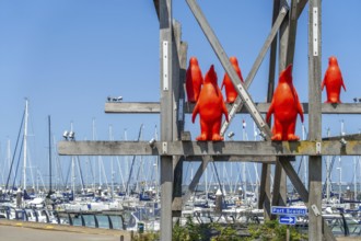 Rode Pinguins, Red Penguins, artwork by Belgian artist William Sweetlove in the marina of Breskens