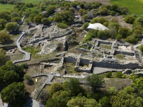 Historical ruins with ancient stone walls embedded in lush vegetation, aerial view, Troy, Troia,