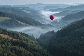 Hot air balloon red, hovering over misty fir forests in soft morning light, few autumnal colours