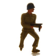 A detailed soldier figurine stands confidently, holding a weapon, set against a bright background.