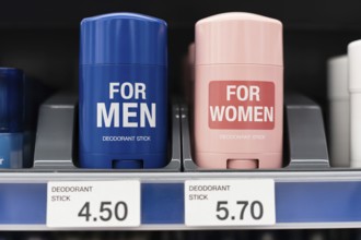 Gender-labeled deodorant sticks with unequal prices. Concept of pink tax in retail. Generative ai,