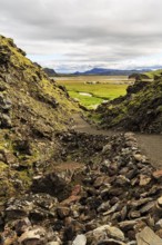 Hiking trail through volcanic landscape, lava rock, view of the campsite in Landmannalaugar,