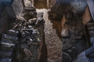 Exposed heating system under the parlour, dated around 1220, coins are from the visitors,