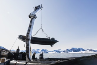 Zodiac on the hook of a ship, sea, Smeerenburg, Spitsbergen, Svalbard