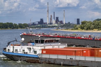 Industrial backdrop of the ThyssenKrupp Steel steelworks in Duisburg-Bruckhausen, cargo ships on