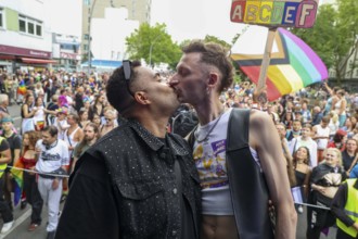 Two kissing men at the 47th Christopher Street Day under the motto Never be quiet again in Berlin