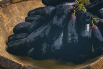 Bunch of black grapes, kishmish variety, black finger, ophelia, Annushka