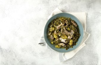 Chakapuli, Georgian dish, stewed meat with herbs and tkemali, in white wine, homemade, no people