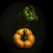 Two vibrant bell peppers, one green and one yellow, are prominently displayed against a black