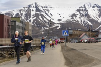 Marathon, group of runners along the city centre, Snow Mountain, Longyearbyen, Spitsbergen,