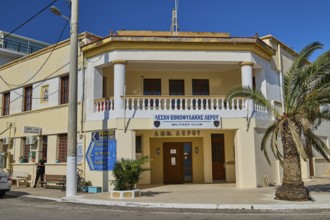 Military club building with columns and palm trees in a street scene, Armando Bernabiti,