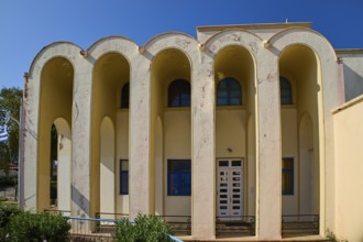 Primary school, Symmetrical building with arched entrances and windows, Armando Bernabiti,