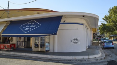 Fish market, A shop with a blue canopy on a street corner, Modern architecture, Armando Bernabiti,