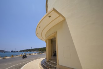 Theatre, Cinema, Round building side with arched architecture and view of street and sea, Armando