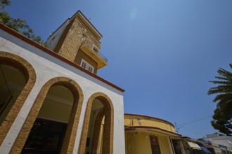 Market hall, Agora, Clock tower in clear style with arches and yellow elements, impresses in the