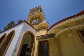 Market Hall, Agora, Historical building with vaulted arches and aged walls under a bright sky,