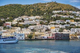 Colourful coastal town in Greece, white and yellow houses on the hillside, Lakki, Leros,
